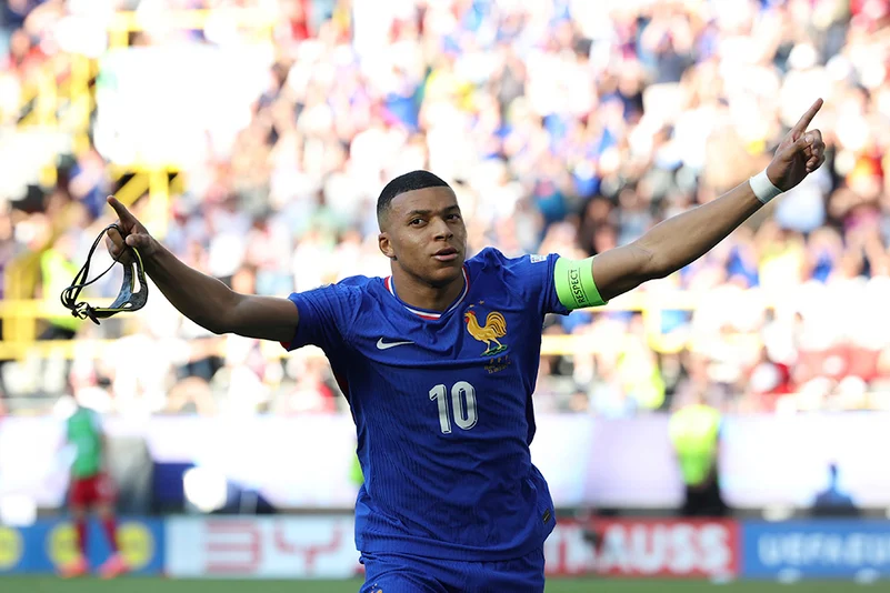 Kylian Mbappe celebrates after scoring a penalty kick against Poland